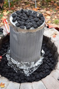 We poured the charcoal on top of the trashcan and around the bottom of it. 